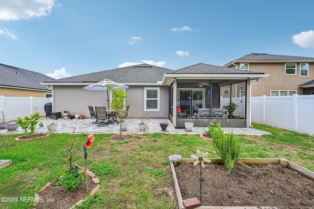 back of house featuring a patio area, ceiling fan, a yard, and a sunroom