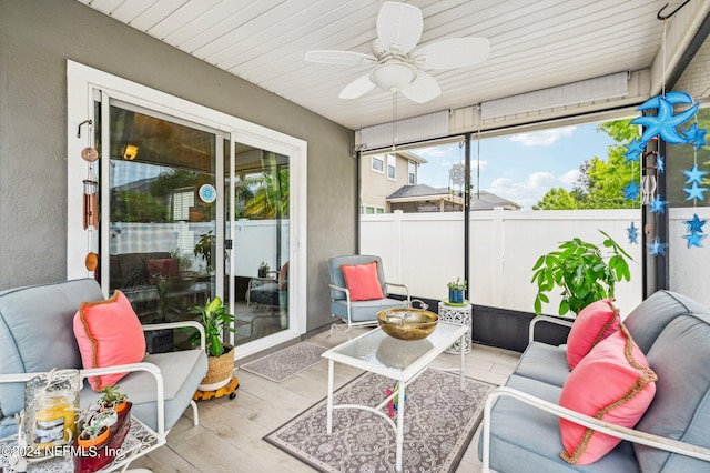 sunroom / solarium featuring ceiling fan