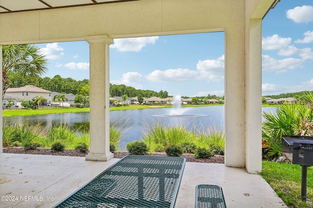 view of patio with a water view