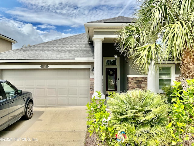 doorway to property with a garage