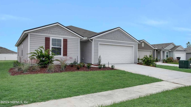 single story home featuring a garage and a front yard