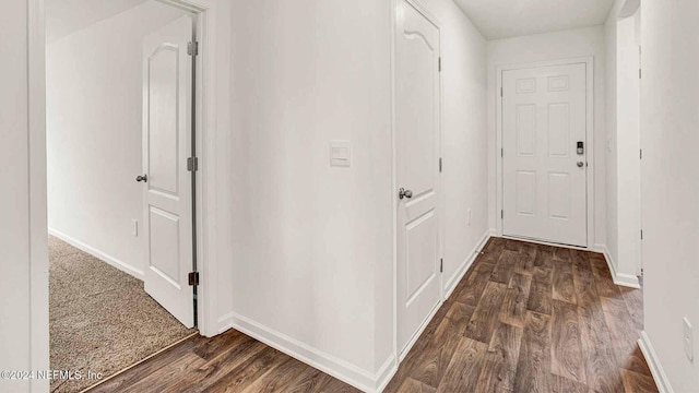 corridor with dark hardwood / wood-style floors