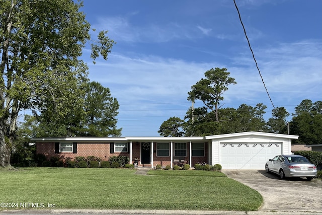 ranch-style house with a porch, a garage, and a front yard