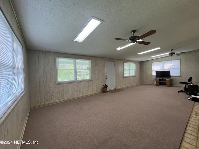 interior space featuring light colored carpet and a textured ceiling