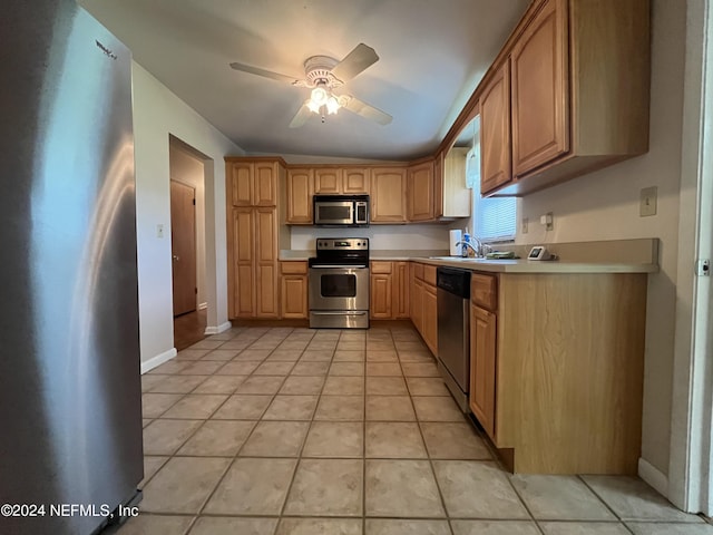 kitchen featuring appliances with stainless steel finishes, light tile patterned floors, sink, ceiling fan, and lofted ceiling