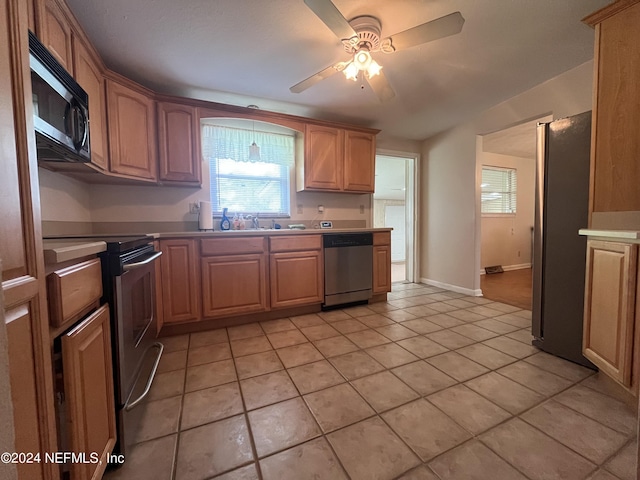 kitchen with sink, stainless steel appliances, ceiling fan, and light tile patterned flooring