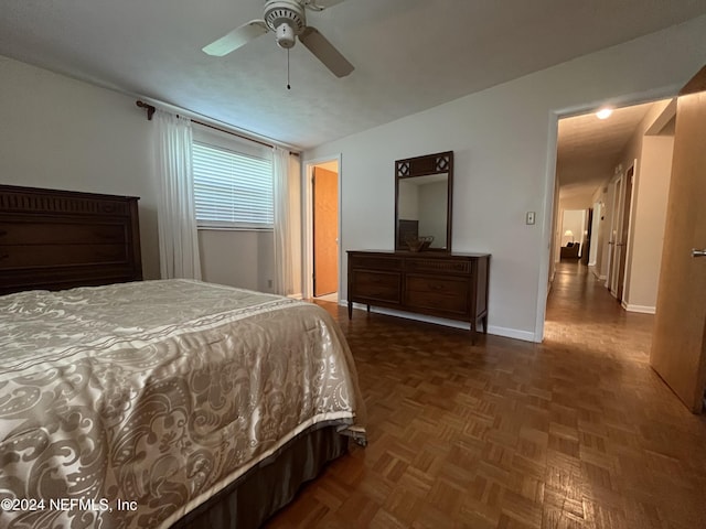 bedroom with ceiling fan and dark parquet floors