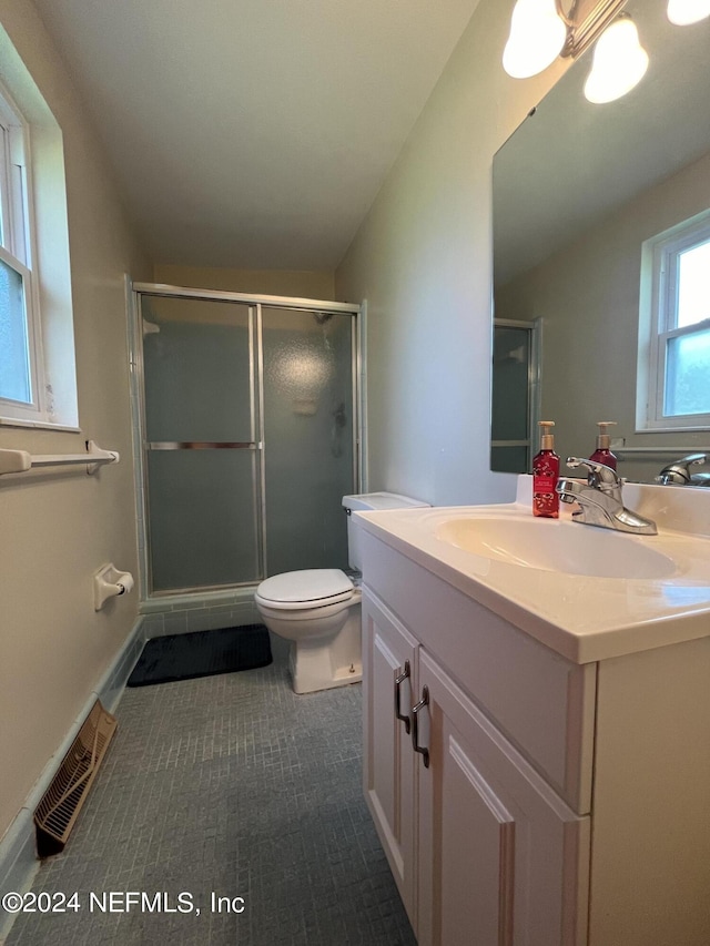 bathroom with toilet, tile patterned flooring, an enclosed shower, and vanity