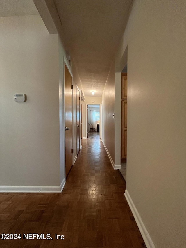 hallway with dark parquet flooring