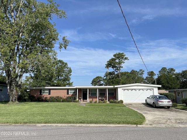 view of front of house with a garage and a front lawn