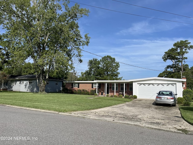 ranch-style house featuring a garage and a front lawn