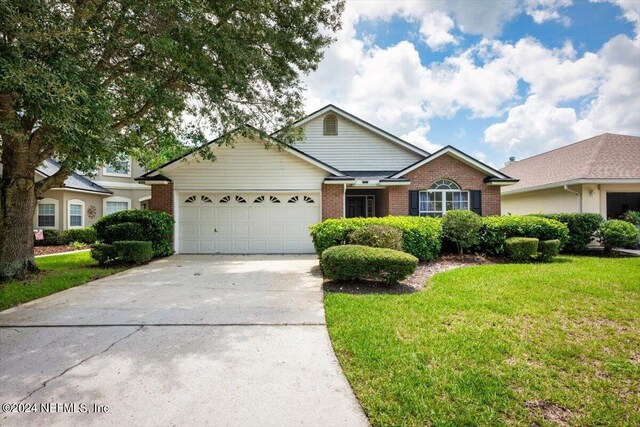 ranch-style house with a garage and a front yard