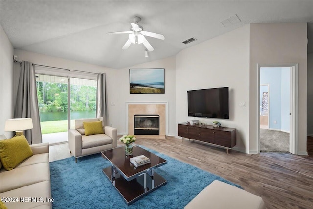 living room with vaulted ceiling, ceiling fan, and wood-type flooring