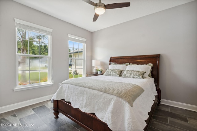 bedroom with ceiling fan and dark hardwood / wood-style flooring