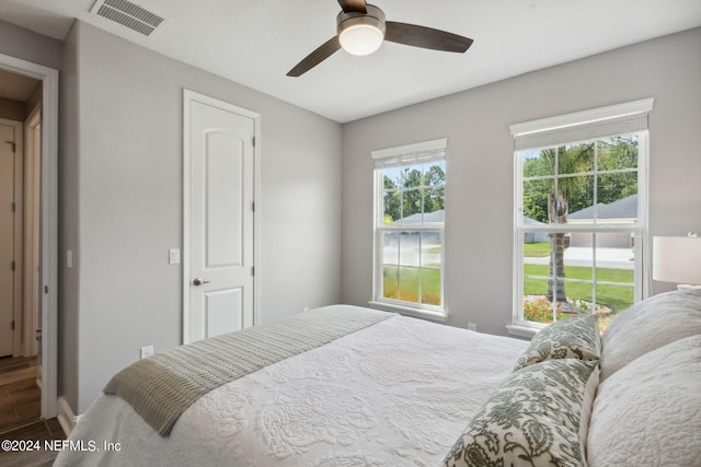 bedroom featuring ceiling fan and dark hardwood / wood-style floors