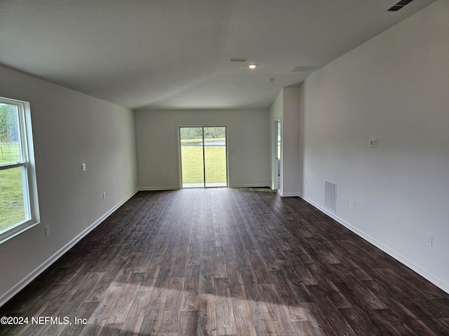 empty room featuring dark wood-type flooring