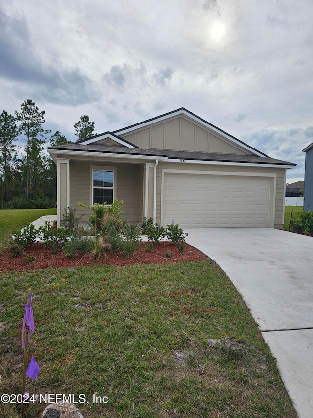 view of front of house with a front yard and a garage