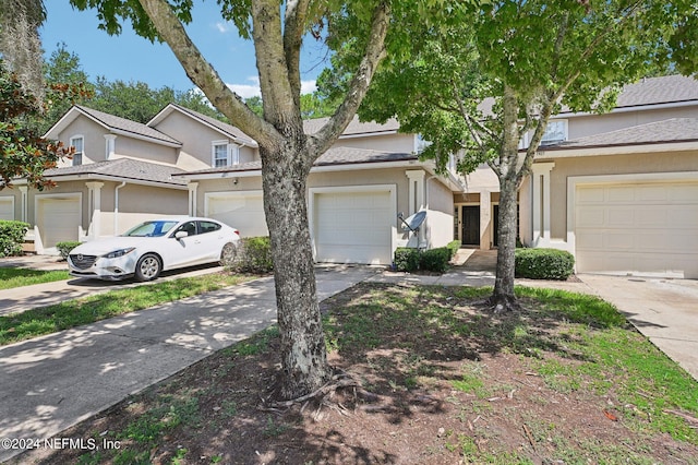 multi unit property with driveway and stucco siding