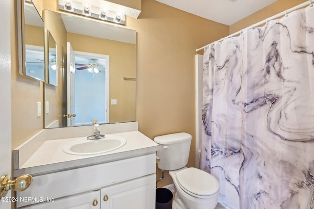 bathroom with vanity, ceiling fan, and toilet