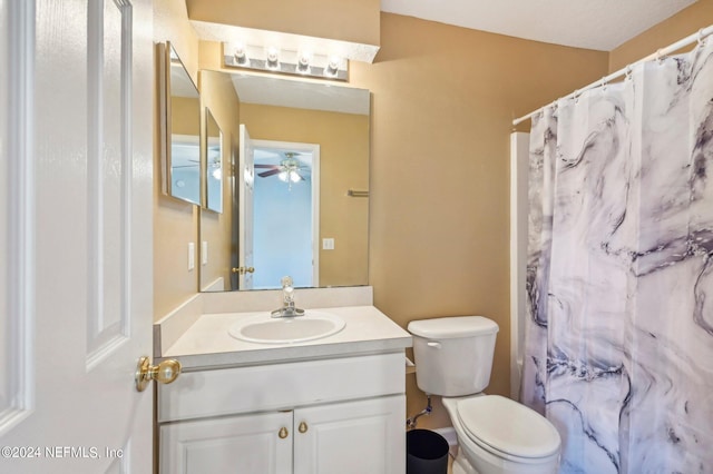 bathroom featuring vanity, toilet, and ceiling fan