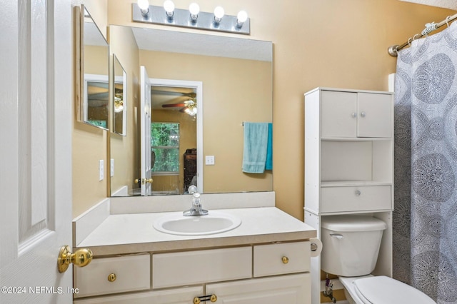 bathroom featuring vanity, ceiling fan, and toilet