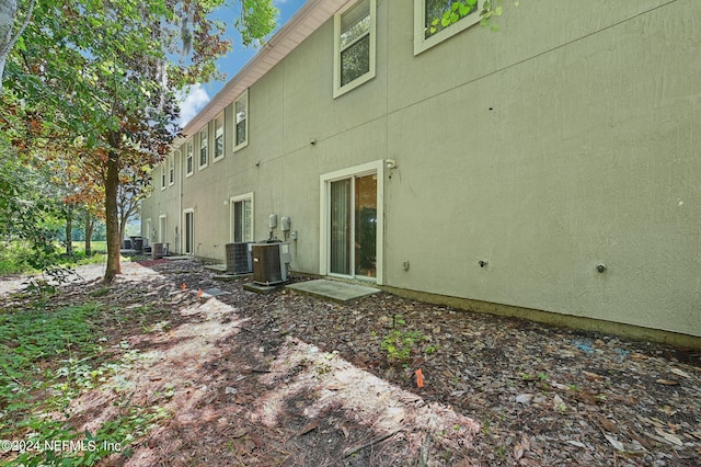 rear view of property with central AC