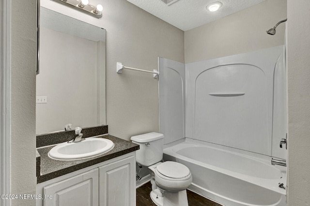 full bathroom featuring shower / bathing tub combination, vanity, toilet, a textured ceiling, and wood-type flooring