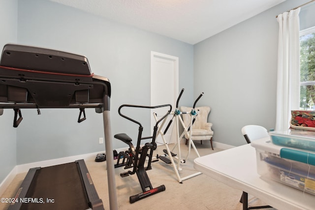 workout room with carpet flooring and baseboards