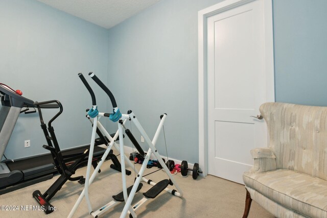 exercise room featuring carpet flooring and baseboards