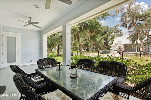 view of patio / terrace featuring outdoor dining area, fence, and a ceiling fan