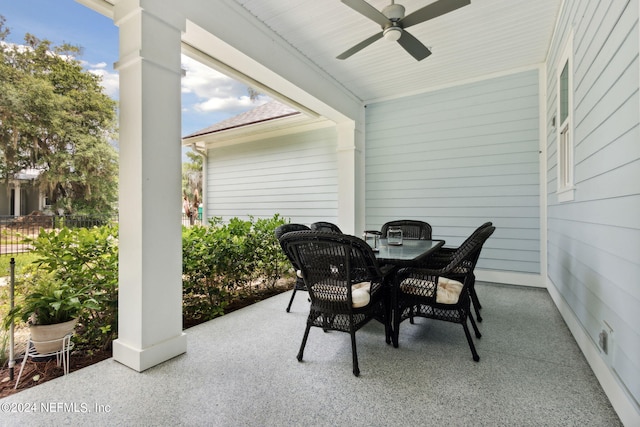 view of patio with outdoor dining space and a ceiling fan