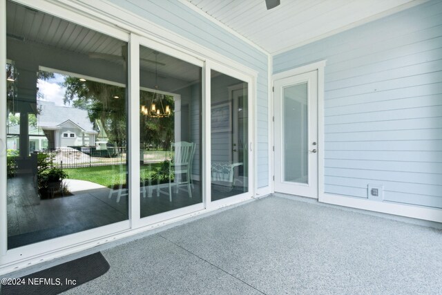 unfurnished sunroom with an inviting chandelier