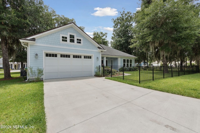 view of front of house featuring a garage, concrete driveway, a front yard, and fence