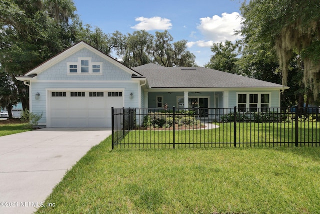 view of front of property with a garage, concrete driveway, a fenced front yard, and a front yard