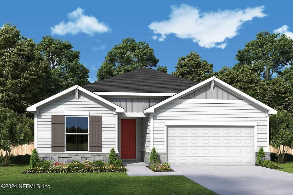 view of front of house featuring a garage and a front lawn