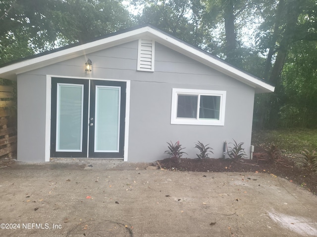 back of property featuring an outdoor structure