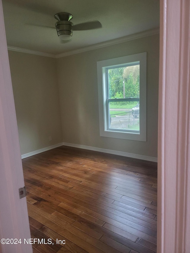 unfurnished room featuring crown molding, ceiling fan, and dark hardwood / wood-style floors