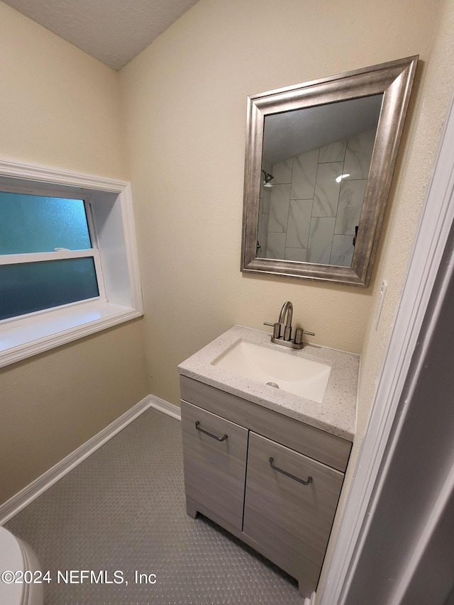 bathroom with baseboards and vanity