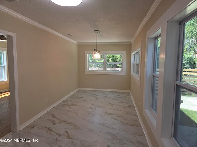 unfurnished dining area with crown molding and a textured ceiling