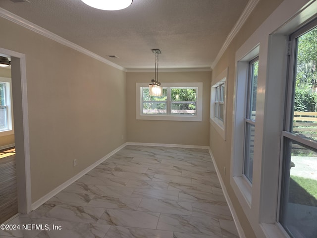 interior space with a textured ceiling, marble finish floor, ornamental molding, and baseboards