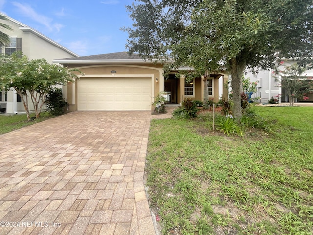 view of front of house with a front lawn and a garage