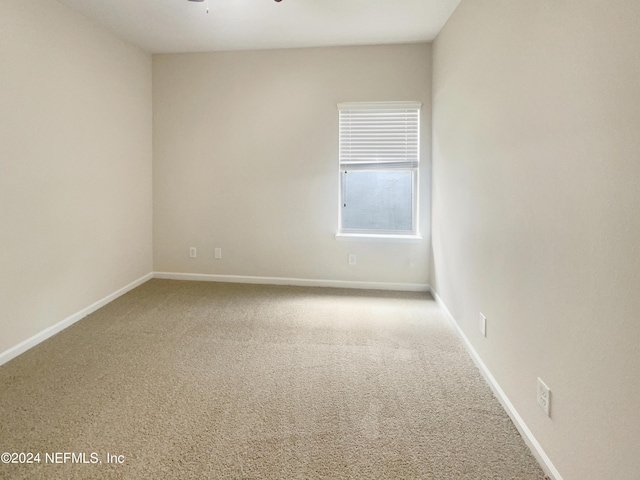 spare room with ceiling fan and carpet floors