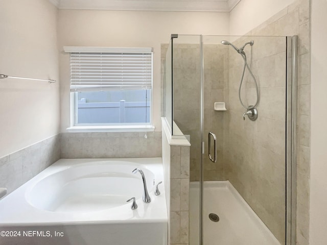 bathroom with separate shower and tub and ornamental molding