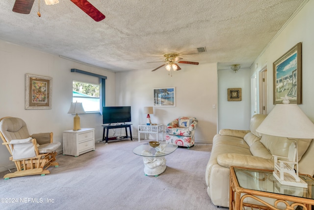 living room featuring carpet floors, a textured ceiling, and ceiling fan