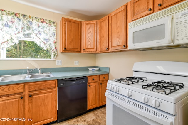 kitchen with sink, light tile patterned floors, and white appliances