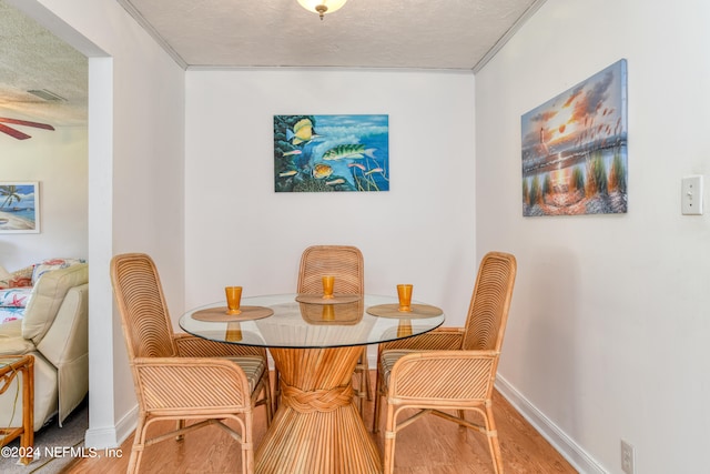 dining space featuring a textured ceiling and hardwood / wood-style flooring