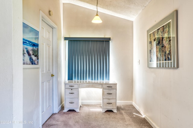 bedroom with carpet floors, a textured ceiling, and lofted ceiling