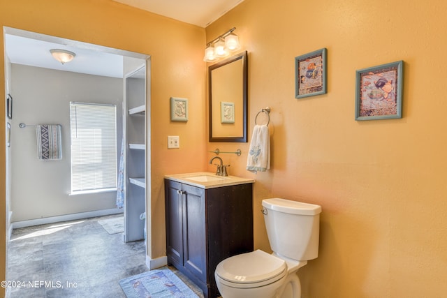 bathroom featuring vanity, tile patterned floors, and toilet