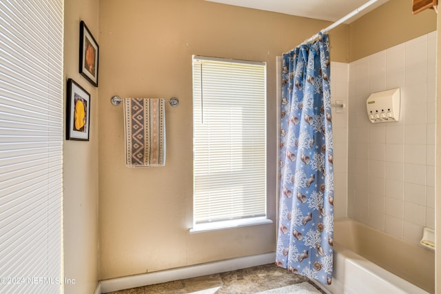 bathroom with shower / bath combination with curtain