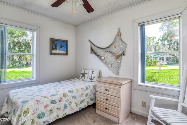 bedroom with multiple windows, carpet flooring, and ceiling fan